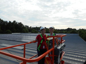 BMS DIRECT SOLAR PANELS on roof with employees